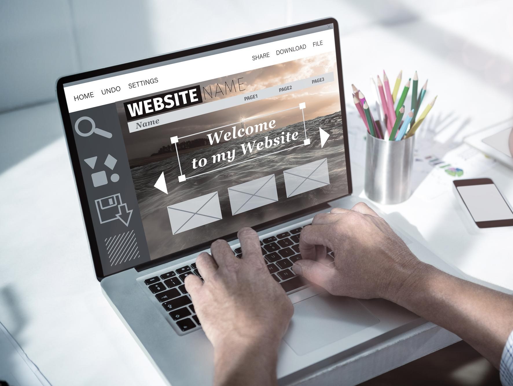 Designing website homepage on laptop screen