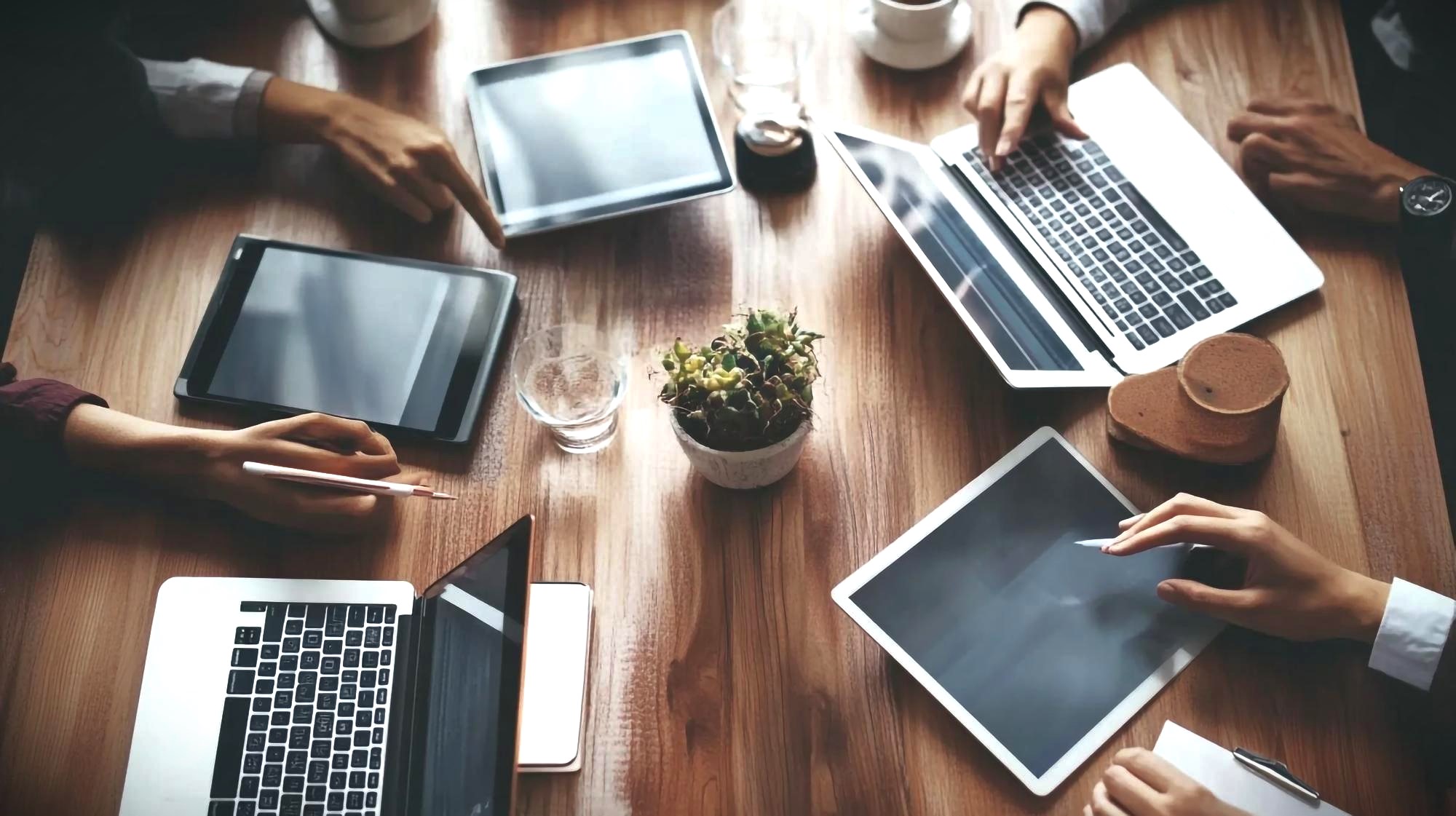  Small team workspace with laptops and tablets for CI/CD plannin